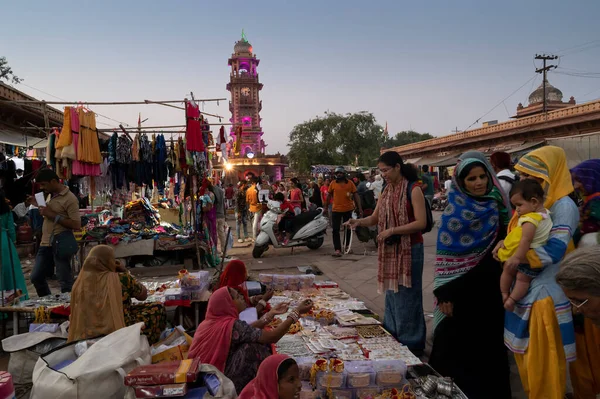 stock image Jodhpur, Rajasthan, India - 19.10.2019 : Rajasthani women are buying bangles and jewelry at famous Sardar Market and Ghanta ghar Clock tower in Jodhpur, Rajasthan, India.