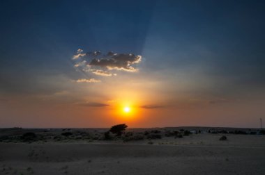 Beautiful sunset at sand dunes of Thar desert, Rajasthan, India. cloudy sky above.