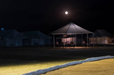 Thar desert, Rajasthan, India - October 15th 2019 : Moon rise behind desert camps at Thar desert.