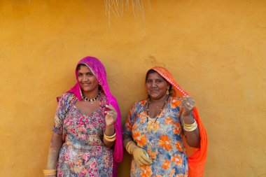 Jaisalmer, Rajasthan, India - 15th October 2019 : Smiling and happy Rajasthani women in local costume, posing in a Rajasthani village.