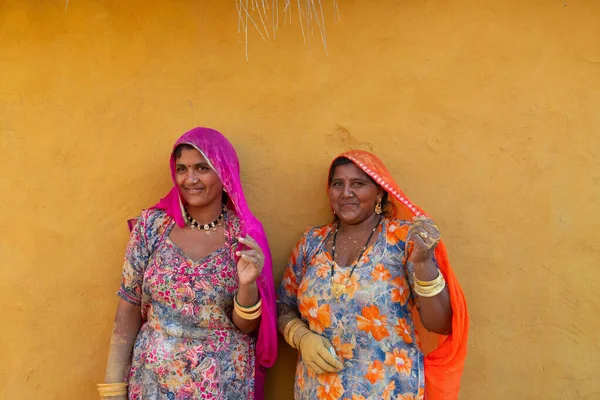 Jaisalmer, Rajasthan, India - 15th October 2019 : Smiling and happy Rajasthani women in local costume, posing in a Rajasthani village.