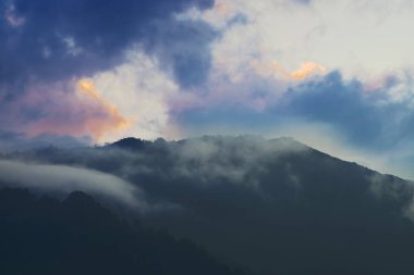 White cloud of the Himalayan mountain range, sun set sky in the background. Shot at Okhrey, Sikkim, India.