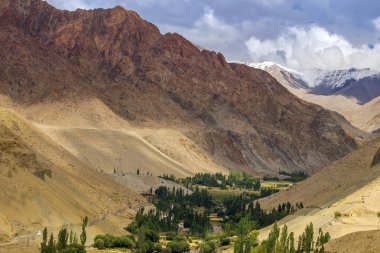 Beautiful play of light on the valley of Basgo, snow capped Himalayan mountains in the background. Leh, Union territory of Ladakh, India.