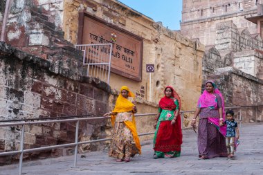 Jodhpur, Rajasthan, India - 19th October 2019 : Rajasthani women wearing colourful Indian sarees visting Mehrangarh fort. Unesco World heritage site, popular tourist spot for International tourists.