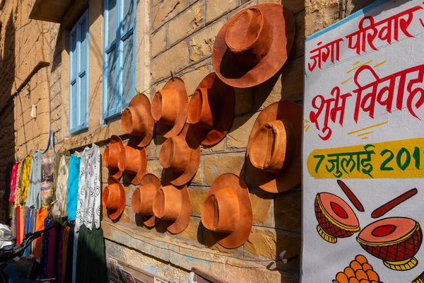 stock image Jaisalmer, Rajasthan, India - October 13, 2019 : Colourful hats are displayed for sale to tourists in market place Inside Jaisalmer Fort, in the morning. Popular UNESCO world heritage site.