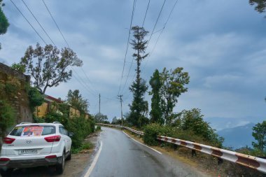 Pauri, Garhwal, Uttrakhand, Hindistan - 3 Kasım 2018: Pauri tepelerinde muson yağmurları. Himalayalar dağlarındaki işlek bir kasabanın yağmurlu sokak görüntüsü. Himalayalar üzerinde iklim değişikliği etkisi.