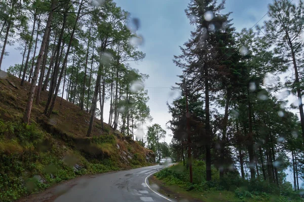 stock image Cloudy sky and curve of Himalayan road, monsoon landscape of Garhwal, Uttarakhand, India. Climate change effect on Himalays bringing landslide, untimely rain and destruction of mountain environment.