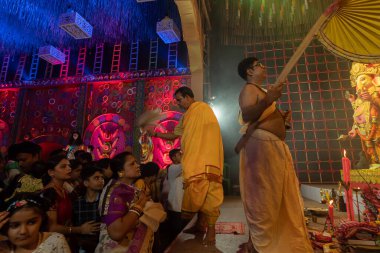 Howrah, Batı Bengal, Hindistan - 3 Ekim 2022: Hindu Rahiplerin kutsaması Chamor ile dua edenler, Durga Puja pandalının içinde fanı çırpın. Gece Ashtami puja aarati. Hinduizm 'in en büyük fetsivası.