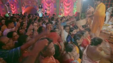 Howrah, Batı Bengal, Hindistan - 3 Ekim 2022: Hindu fanatikler, Puspanjali bittikten sonra çiçek yaprağı topluyor, Durga Puja Pandalı 'nın içinde tanrıça Durga' ya ibadet ve ibadet için bir ritüel..