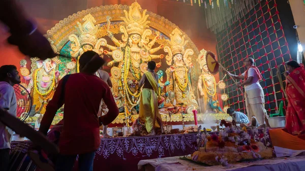 Howrah, Batı Bengal, Hindistan - 5 Ekim 2022: Dhaakis, Durga puja pandalının içinde kutsal dumanla kaplanmış dhaaks oynarken Tanrıça Durga 'ya kutsal tatlı Vog sunan Hindu Purohits.