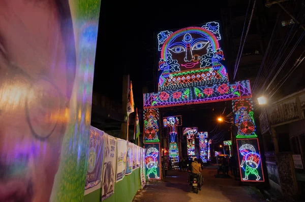 stock image Howrah, West Bengal, India- 3rd October, 2022 : Decorated and illuminated street during Durga puja festival night. Durga puja is biggest festival of Hindusim.