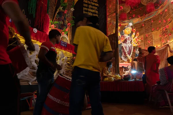 stock image Howrah, West Bengal, India - 3rd October 2022 : Dhaakis playing dhaaks for worshipping Goddess Durga. A sacred Durga Puja ritual. Decorated pandal for Goddess Durga, biggest festival of Hinduism.