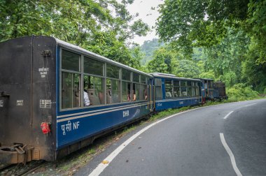 Darjeeling,West Bengal,India - 10th August 2023 : Diesel Toy train, running over narrow gauge railway between New Jalpaiguri and Darjeeling, beside Himalayan roads. Darjeeling Himalayan Railway,