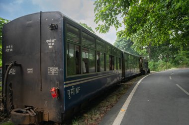 Darjeeling,West Bengal,India - 10th August 2023 : Diesel Toy train, running over narrow gauge railway between New Jalpaiguri and Darjeeling, beside Himalayan roads. Darjeeling Himalayan Railway,