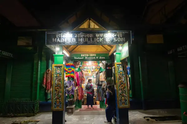 stock image Darjeeling, West Bengal, India - 10.08.2023 : Night time view of Darjeeling Mall. Famous shop of Habeeb Mullick & Son, famous for selling various items including clothes, sweater, gift items etc.