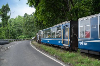 Darjeeling,West Bengal,India - 10th August 2023 : Diesel Toy train, running over narrow gauge railway between New Jalpaiguri and Darjeeling, beside Himalayan roads. Darjeeling Himalayan Railway,