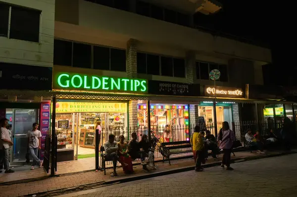 stock image Darjeeling, West Bengal, India - 10.08.2023 : Night time view of Darjeeling Mall. World famous and very popular Darjeeling tea is being sold from Golden Tips, retail outlet, to customers and visitors.