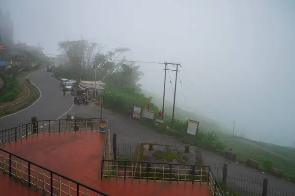 stock image Monsoon clouds passing over Gidda Pahar, view point, Kurseong, Himalayan mountains of Darjeeling, West Bengal, India. Darjeeling is queen of hills and very scenic with green hills in rainy season.