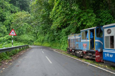 Darjeeling,West Bengal,India - 10th August 2023 : Diesel Toy train, running over narrow gauge railway between New Jalpaiguri and Darjeeling, beside Himalayan roads. Darjeeling Himalayan Railway, clipart