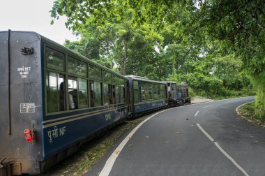 Darjeeling,West Bengal,India - 10th August 2023 : Diesel Toy train, running over narrow gauge railway between New Jalpaiguri and Darjeeling, beside Himalayan roads. Darjeeling Himalayan Railway, clipart