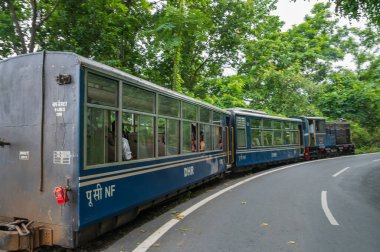 Darjeeling,West Bengal,India - 10th August 2023 : Diesel Toy train, running over narrow gauge railway between New Jalpaiguri and Darjeeling, beside Himalayan roads. Darjeeling Himalayan Railway,