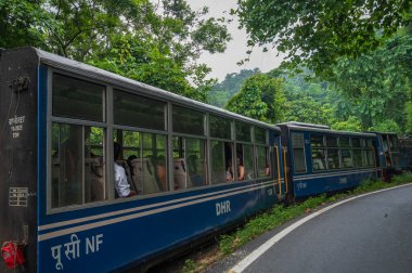 Darjeeling,West Bengal,India - 10th August 2023 : Diesel Toy train, running over narrow gauge railway between New Jalpaiguri and Darjeeling, beside Himalayan roads. Darjeeling Himalayan Railway,