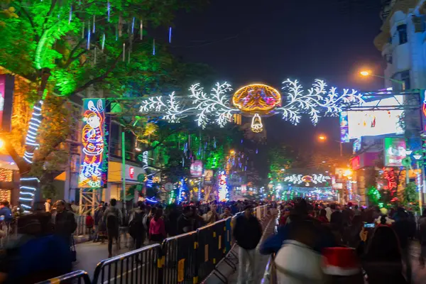 Stock image Kolkata, West Bengal, India - 26.12.2018 : Christmas celebration by enthusiastic young public at illuminated and decorated park street with lights and year end festive mood. Evening sky background.