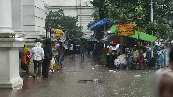 stock image Kolkata, West Bengal, India - 16th August 2019 : Pedestrians walking through waterlogged footpath near Indian museuam. Monsoon at Kolkata,