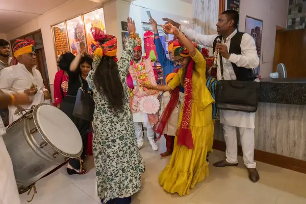 stock image Jodhpur,Rajasthan,India - 19.10.2019 : Groom dancing wearing garland of money for Baraat or procession to reach the wedding venue , dance with female family members. Sindhi marriage ceremony in hotel.