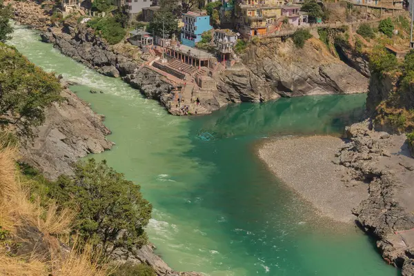 stock image Bhagirathi river from left side and Alakananda river with turquoise blue colour from right side converge at Devprayag,Holy conflunece and form river Holy Ganges thereafter.Garhwal, Uttarakhand, India.