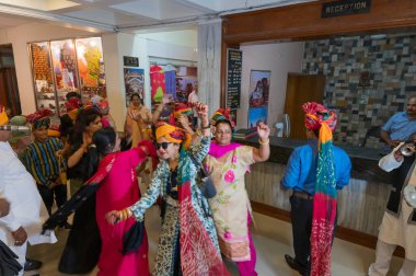 Jodhpur, Rajasthan, India - 19.10.2019 : Females wearing traditional colorful wedding turbans, dancing in Joy, happiness for celebration of Sindhi marriage organized in a hotel. Destination wedding. clipart