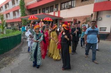 Jodhpur, Rajasthan, Hindistan - 19.10.2019: Baraat. Düğün türbanlı bayanlar Sindhi düğününü kutlamak ve damadı at üstünde düğün yerine götürmek için yürüyüş yapmaktan zevk alıyorlar. Sindhi evliliği.