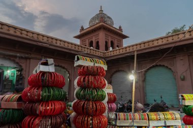 Colorful Rajasthani bangles being sold at famous Sardar Market and Ghanta ghar Clock tower in Jodhpur, Rajasthan, India. clipart