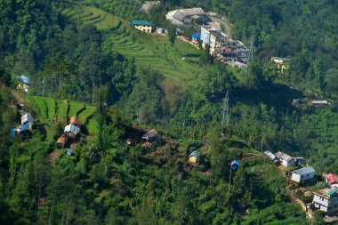 early morning light on Padamchen village, Sikkim. Himalayan mountain slope, India. Sikkim is full of villages located on the scenic Himalayan mountains. clipart