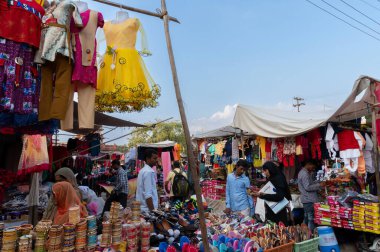 Jodhpur, Rajasthan, India - 20.10.2019 : Rajasthani buyers and sellers at famous Sardar Market and Ghanta ghar Clock tower in Jodhpur, Rajasthan, India. clipart