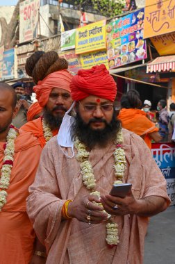 Haridwar, Uttarakhand, Hindistan - 13 Nisan 2021: Hindu sadhus, safran elbiseli sanyasis Ganj Nehri 'ndeki Shahi snaan için geçit töreni düzenliyor. Kumbhmela olayı.