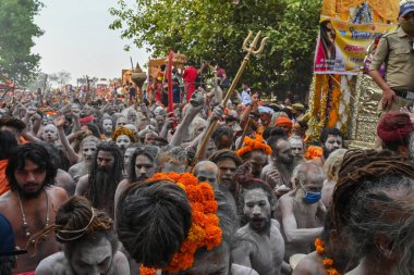 Haridwar, Uttarakhand, Hindistan - 13 Nisan 2021: Hindu çıplak sadhus, naga babas, naga sanyasis Ganj nehrinde shahi snaan yemek ve Har Har Mahadev diye bağırmak için koşuyor. Kumbhmela olayı.