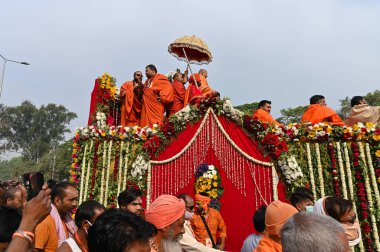 Haridwar, Uttarakhand, Hindistan - 13 Nisan 2021: Maha Kumbhmela etkinliği. Sadhus, safranlı Sanyasis Ganj nehrinde shahi snaan yemek için traktörlere biniyor. Kullarının ellerini kaldır..