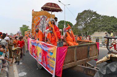 Haridwar, Uttarakhand, Hindistan - 13 Nisan 2021: Maha Kumbhmela etkinliği. Sadhus, safranlı Sanyasis Ganj nehrinde shahi snaan yemek için traktörlere biniyor. Kullarının ellerini kaldır..