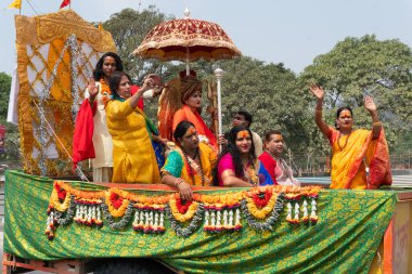 Haridwar, Uttarakhand, India - 16th April 2021 : Hindu transgender devotees going for shahi snaan on Kumbhmela, on decorated vehicles and shouting prayers for Lord Shiva. Maha kumbhmela event. clipart