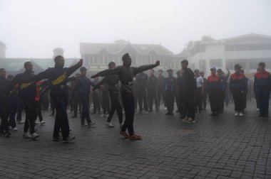 Darjeeling, Batı Bengal, Hindistan-11.08.2023: Sisli sabahta askeri eğitim. 15 Ağustos 2023 'teki Bağımsızlık Günü kutlamaları için Darjeeling Alışveriş Merkezi' nin önünden geçen öğrenciler.,