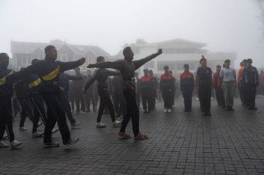 Darjeeling, Batı Bengal, Hindistan -11.08.2023: 15 Ağustos 2023 'te Bağımsızlık Günü kutlamaları için Darjeeling Alışveriş Merkezi' nde yürüyüş yapan öğrenciler, askeri eğitim. Sisli bir sabah.
