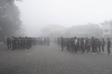 Darjeeling, Batı Bengal, Hindistan -11.08.2023: Bağımsızlık Günü hazırlığı 15 Ağustos 2023. Askeri eğitim için Darjeeling Alışveriş Merkezi 'nin önünden geçen öğrenciler. Sisli bir sabah.