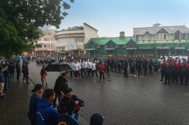 Darjeeling, Batı Bengal, Hindistan -11.08.2023: 15 Ağustos 2023 'te Bağımsızlık Günü kutlamaları için Darjeeling Alışveriş Merkezi' nde yürüyüş yapan öğrenciler, askeri eğitim. Sisli bir sabah.