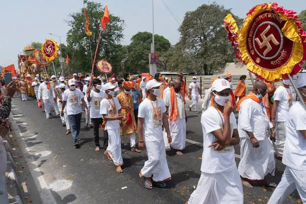 Haridwar, Uttarakhand, Hindistan - 16 Nisan 2021: Maha Kumbhmela etkinliği. Sadhus, bayraklı beyaz elbiseler içinde Sanyasis Ganj Nehri 'nde Shahi Snaan yemek için yürüyüş yapıyor. Hindu etkinliği.