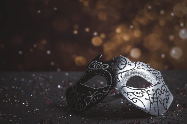 Image of elegant venetian, mardi gras mask on glitter background. Carnival and Mardi Gras party celebration design background