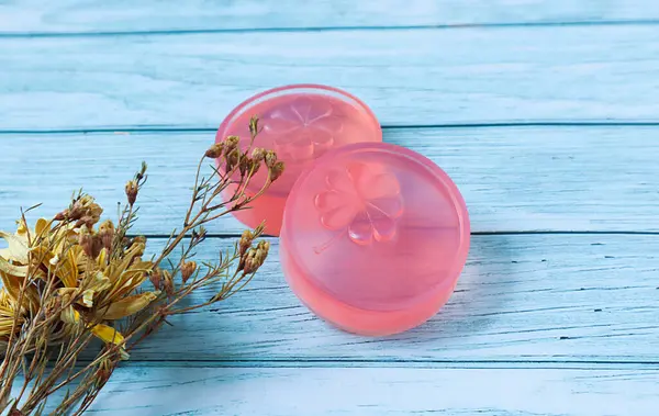 stock image Pink glycerin soap on the background is old wood., Product care about clean and soft body skin., Daily beauty product.