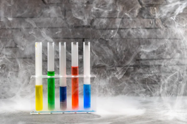 chemical flasks with colored fluids and fog around