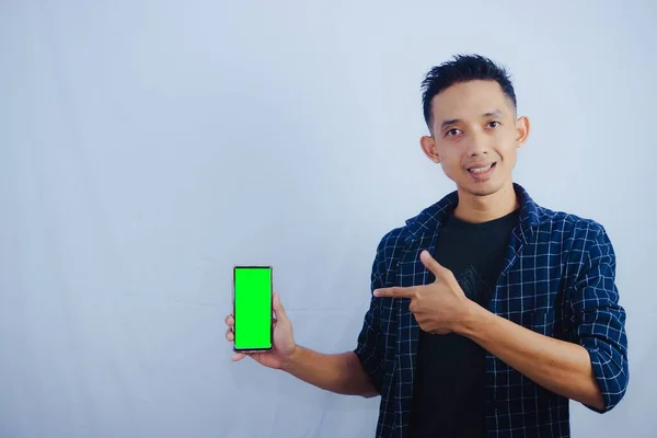 Mladý Asiat Drží Smartphone Zobrazení Jeho Displej Telefon Zelenou Obrazovkou — Stock fotografie