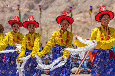 Ladakh 'lı genç kızlar 23 Mayıs 2024' te Leh, Ladakh Hindistan 'da geleneksel kostüm ve şapkalarını giyip dans ediyorlar..